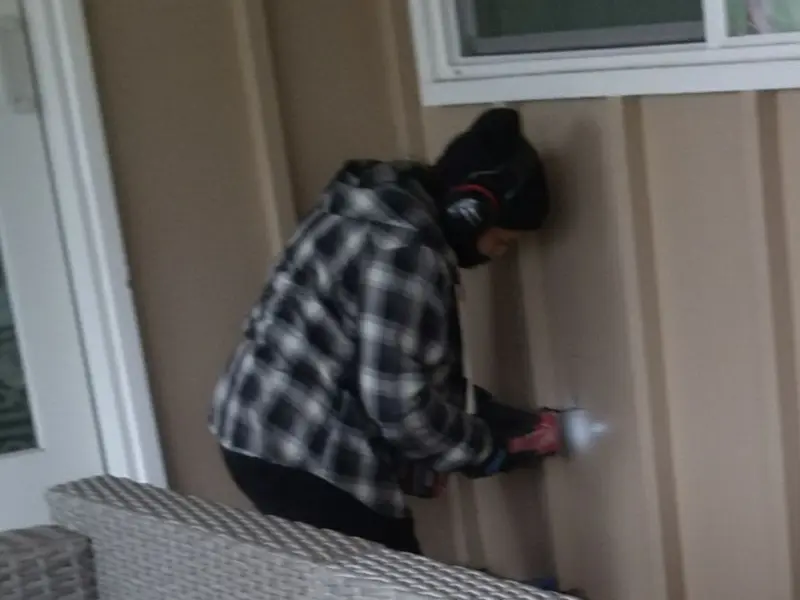 Professional electrician installing an exterior outlet in Littlefield